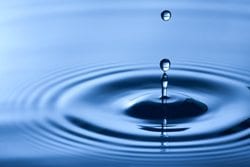 Manufacturing Water Treatment Chemicals and Safety - Image of a water drop hitting a pool of blue water